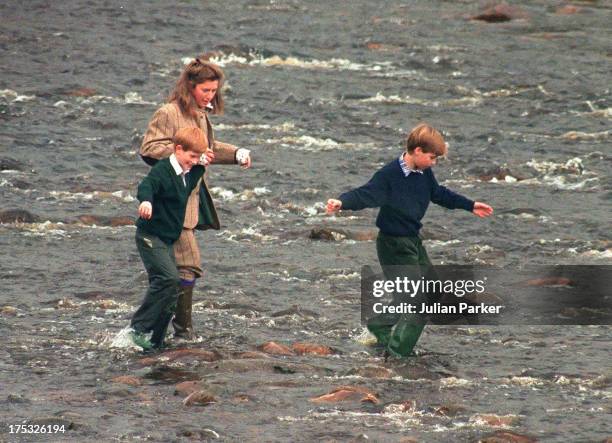 Royal Nanny, Tiggy Legge-Bourke, Prince William,and Prince Harry walk in the River Gairn, near the Balmoral Estate on October 22, 1994 in Balmoral,...