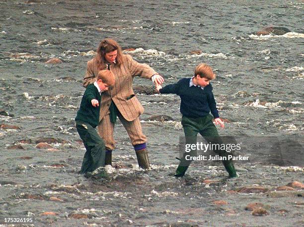 Royal Nanny, Tiggy Legge-Bourke, Prince William,and Prince Harry walk in the River Gairn, near the Balmoral Estate on October 22, 1994 in Balmoral,...