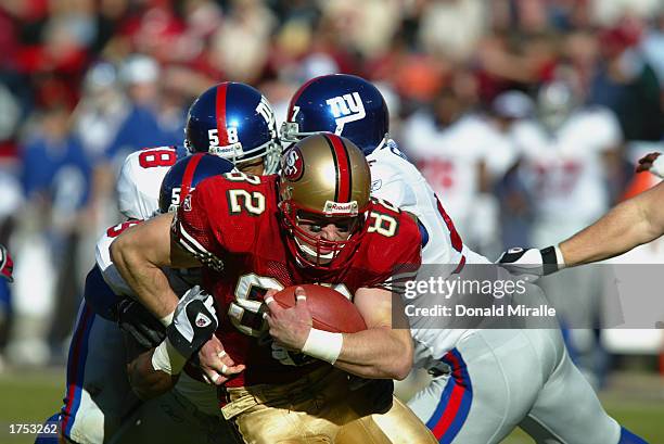 Tight end Eric Johnson of the San Fransisco 49ers is brought down after a reception against the New York Giants during the NFC Wild Card game at 3Com...