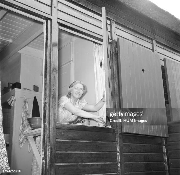 Sepha van Beinum-Janssen, the wife of conductor Eduard van Beinum closes a kitchen window of their Bergsham country house in Garderen ca: June 5,...