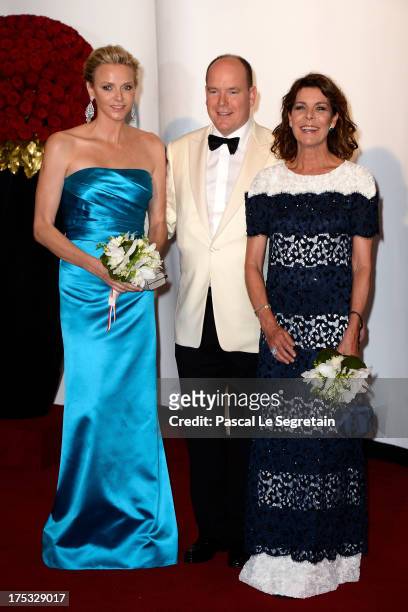Princess Charlene of Monaco, Prince Albert II of Monaco and Princess Caroline of Hanover attend the 65th Monaco Red Cross Ball Gala at Sporting...