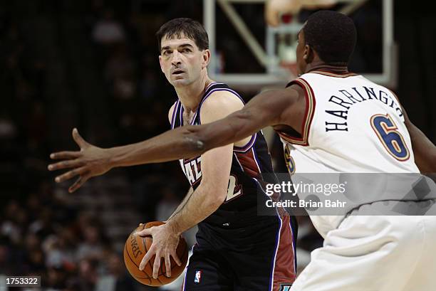 John Stockton of the Utah Jazz is defended by Junior Harrington of the Denver Nuggets during the game at Pepsi Center on January 15 2003 in Denver,...