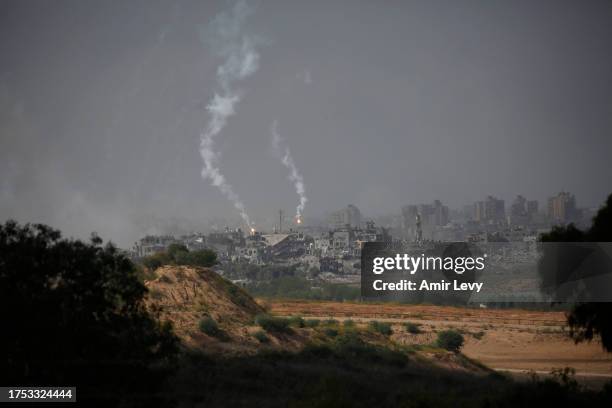 Flares fired from Israeli artillery positions descend on Beit Hanoun in the Gaza Strip on October 30, 2023 as seen from Sderot, Israel. As Israel's...