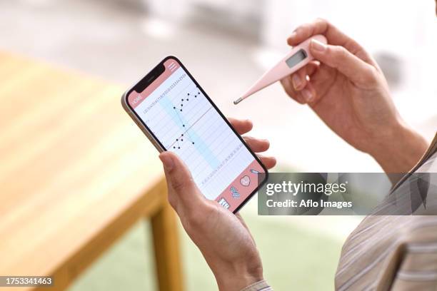 woman checking temperature - taking temperature stock pictures, royalty-free photos & images