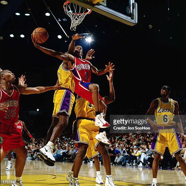 Allen Iverson of the Philadelphia 76ers battles to the basket for an ally-oop layup against the Los Angeles Lakers at the Staples Center during the...