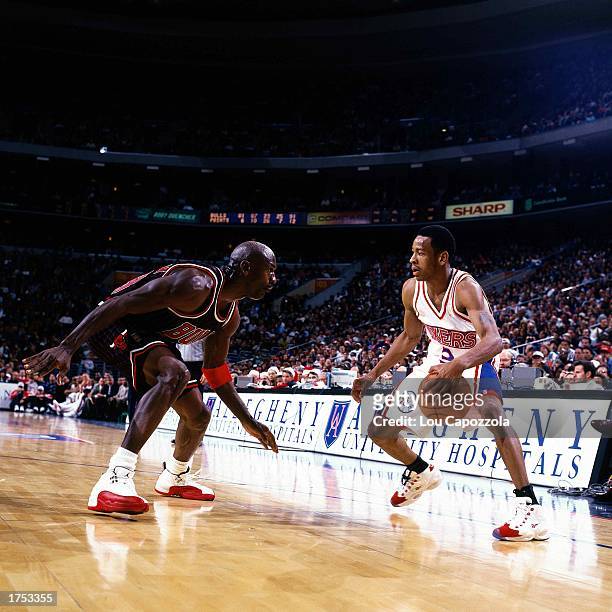 Allen Iverson of the Philadelphia 76ers faces off at the perimeter against Michael Jordan of the Chicago Bulls at the First Union Center during the...
