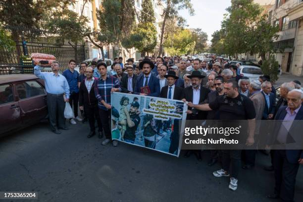 Rabbi Younes Hamami Lalehzar, Leader of Iranian Jews, and two other Jewish Rabbis, stand behind an anti-Israeli banner during a rally in support of...