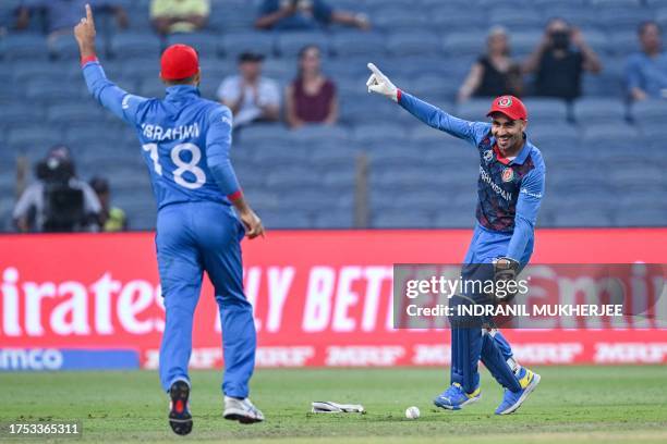 Afghanistan's Rahmanullah Gurbaz celebrates with teammate Ibrahim Zadran after the dismissal of Sri Lanka's Kasun Rajitha during the 2023 ICC Men's...