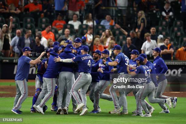 The Texas Rangers celebrate after defeating the Houston Astros in Game Seven to win the American League Championship Series at Minute Maid Park on...