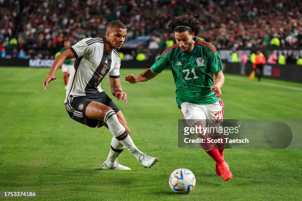 Cesar Huerta of Mexico and Jonathan Tah of Germany compete for the ball during the second half of the international friendly at Lincoln Financial...
