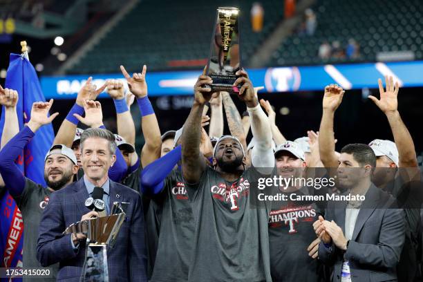 Adolis Garcia of the Texas Rangers hoist the ALCS MVP Trophy after defeating the Houston Astros in Game Seven to win the American League Championship...