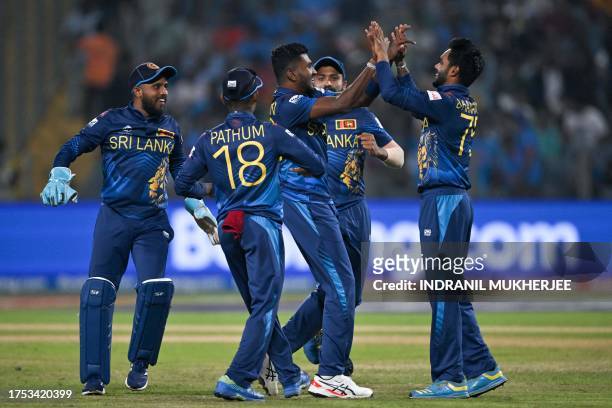 Sri Lanka's players celebrate after the dismissal of Afghanistan's Rahmanullah Gurbaz during the 2023 ICC Men's Cricket World Cup one-day...