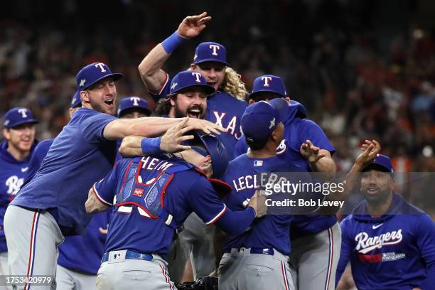 Jose Leclerc of the Texas Rangers celebrates with Jonah Heim after defeating the Houston Astros in Game Seven to win the American League Championship...