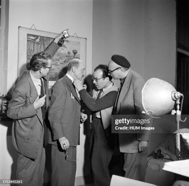 Gerard Rutten looks at the make-up of and actor on a movie set ca: December 10, 1953.