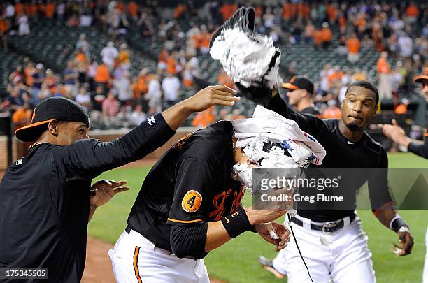 Ryan Flaherty of the Baltimore Orioles gets shaving creamed by Alexi Casilla and Adam Jones after an 11-8 victory against the Seattle Mariners at...