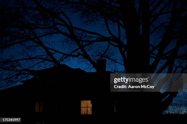 light on - creepy house at night stock-fotos und bilder