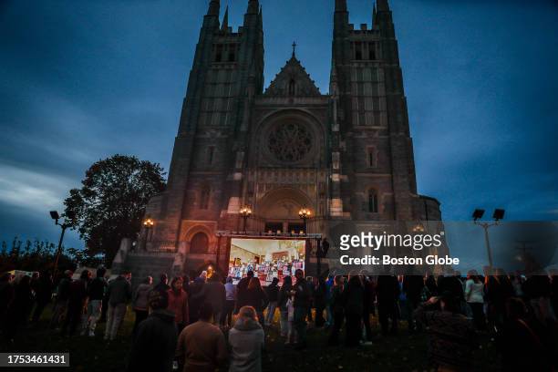 Lewiston, ME Hundreds spilled outside of the Basilica of Saints Peter and Paul while attending a vigil for the 18 people who were killed in...