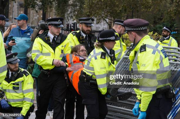 Police officers arrest environmental activists from Just Stop Oil in Parliament Square as they begin their latest round of protest actions against...