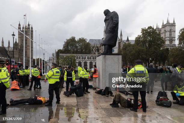 Police officers arrest environmental activists from Just Stop Oil in Parliament Square as they begin their latest round of protest actions against...