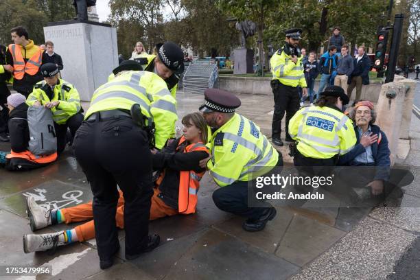 Police officers arrest environmental activists from Just Stop Oil in Parliament Square as they begin their latest round of protest actions against...