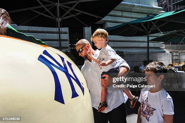 American League All-Star Jesse Crain of the Chicago White Sox signs the American League All-Star Game apple during the 2013 All-Star Red Carpet...