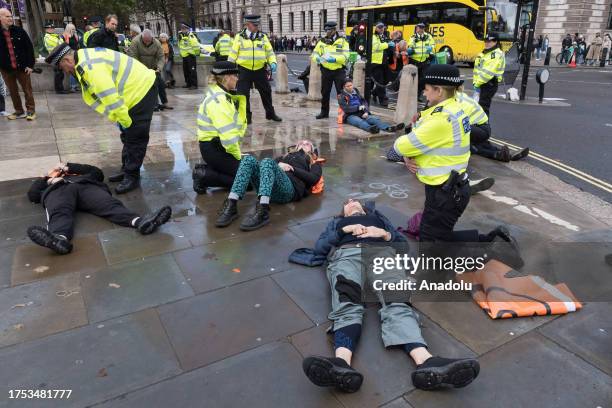 Police officers arrest environmental activists from Just Stop Oil in Parliament Square as they begin their latest round of protest actions against...