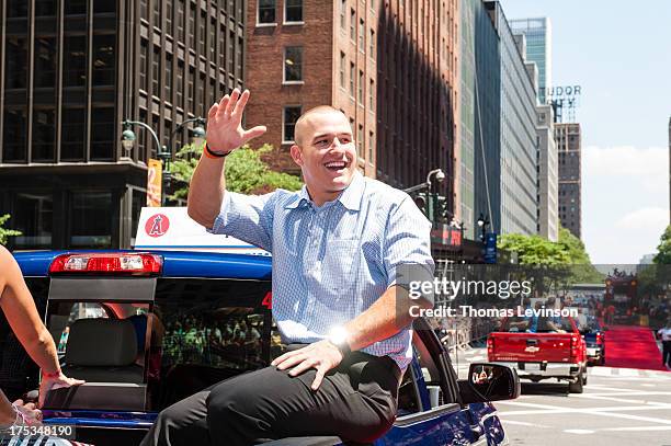 American League All-Star Mike Trout of the Los Angeles Angels waves to fans during the 2013 All-Star Red Carpet Parade presented by Chevrolet on July...