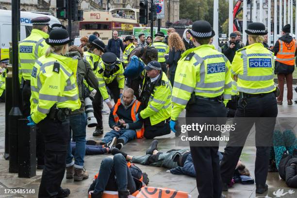 Police officers arrest environmental activists from Just Stop Oil in Parliament Square as they begin their latest round of protest actions against...