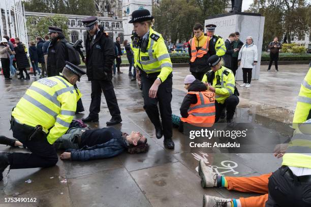 Police officers arrest environmental activists from Just Stop Oil in Parliament Square as they begin their latest round of protest actions against...