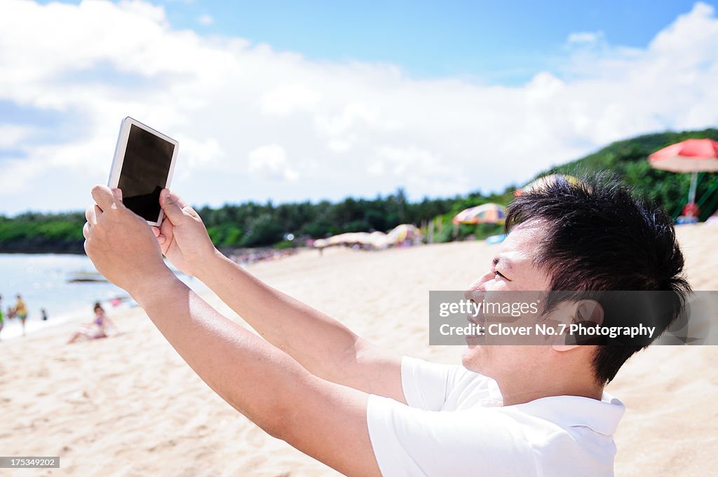 Man using digital tablet shoot landscapes