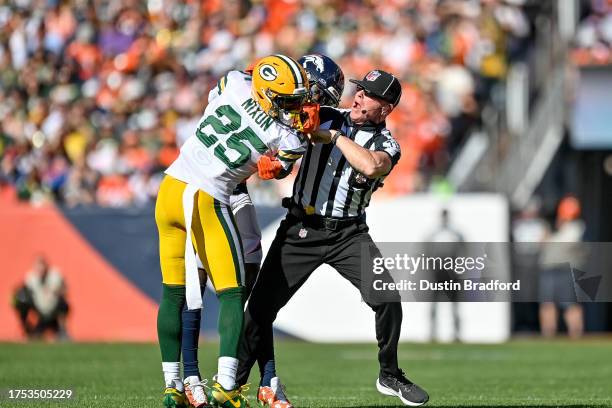 Referee works to separate cornerback Keisean Nixon of the Green Bay Packers and wide receiver Jerry Jeudy of the Denver Broncos after a first quarter...