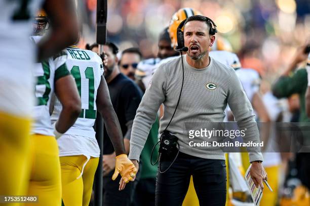 Head coach Matt LaFleur of the Green Bay Packers celebrates with players after a Green Bay Packers touchdown in the fourth quarter against the Denver...