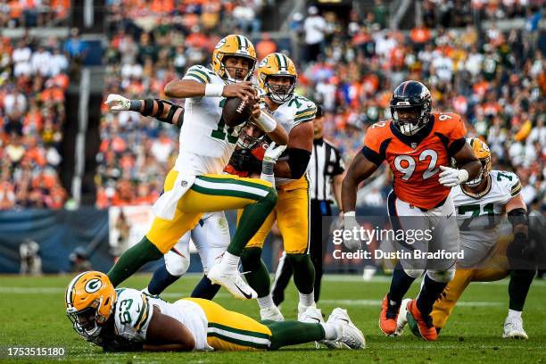 Quarterback Jordan Love of the Green Bay Packers scrambles in the fourth quarter against the Denver Broncos at Empower Field at Mile High on October...