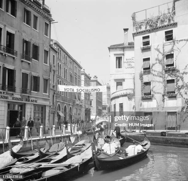 Banner over a canal in Venice that reads 'Vota Socialismo' ca: May 1953.