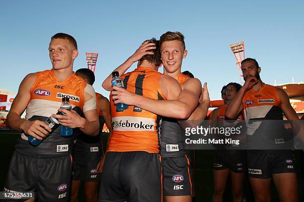 Lachie Whitfield of the Giants celebrates victory with Taylor Adams after the round 19 AFL match between the Greater Western Sydney Giants and the...