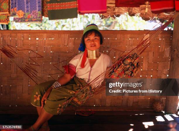 Padaung woman rests in a hammock, Padaung village near Mae Hong Son.