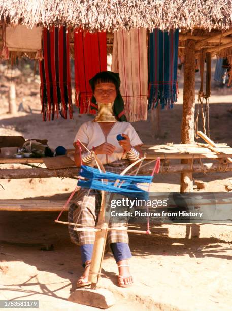 Padaung woman spinning yarn for weaving in a village near Mae Hong Son.