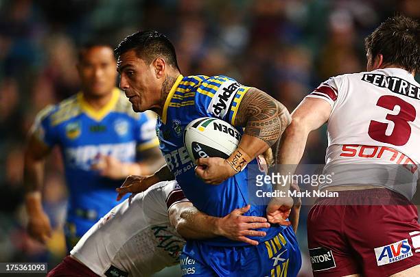 Reni Maitua of the Eels is tackled during the round 21 NRL match between Parramatta Eels and the Manly Sea Eagles at Parramatta Stadium on August 3,...