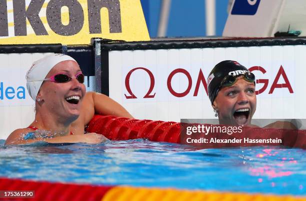 Yuliya Yefimova of Russia celebrates her new world record with Jessica Hardy of the USA after the Swimming Women's 50m Breaststroke preliminaries...