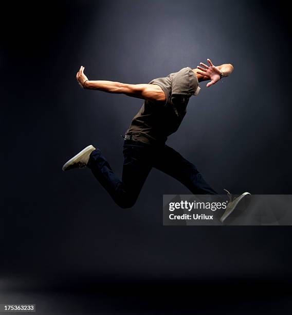 young male hip hop dancer jumping in air - hip hopper stock pictures, royalty-free photos & images