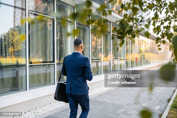 businessman leaving his office at afternoon - closing time stock pictures, royalty-free photos & images