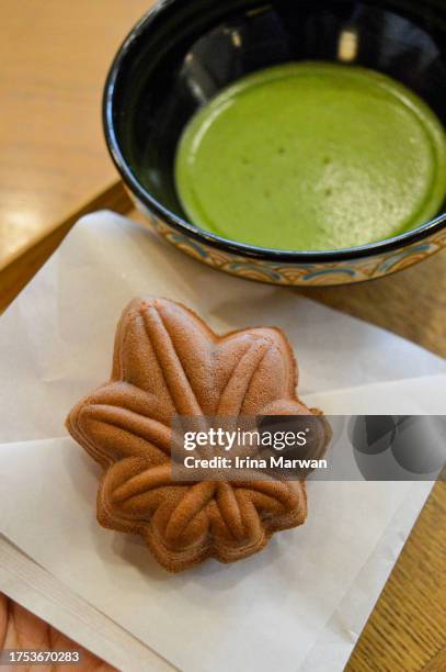 japanese dessert momiji manjū and matcha tea - miyajima stock pictures, royalty-free photos & images