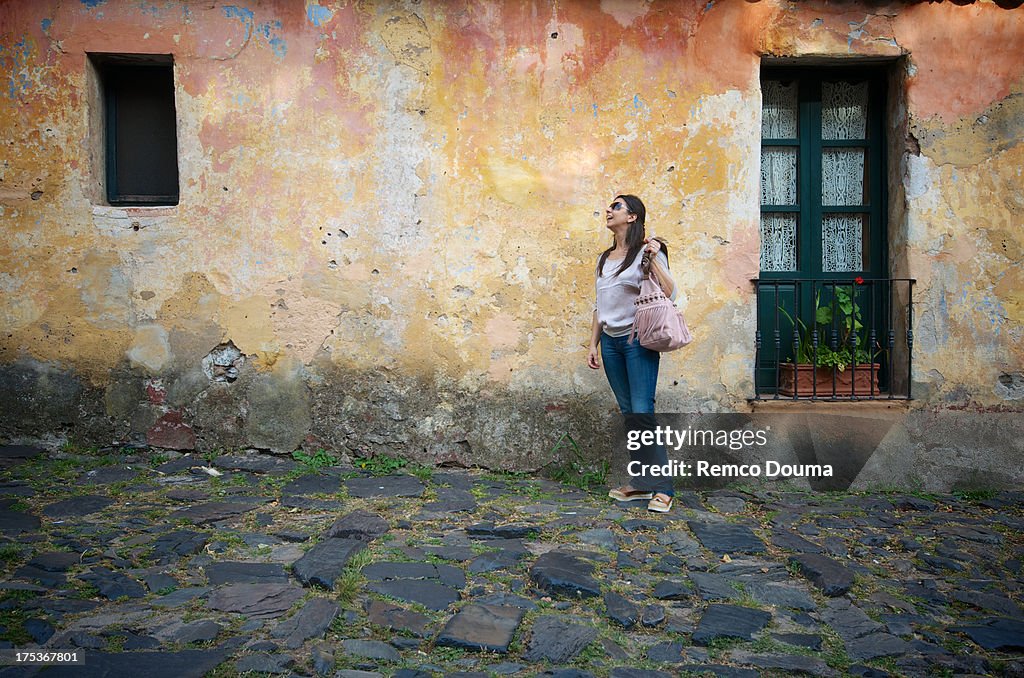 Woman in front of old facade