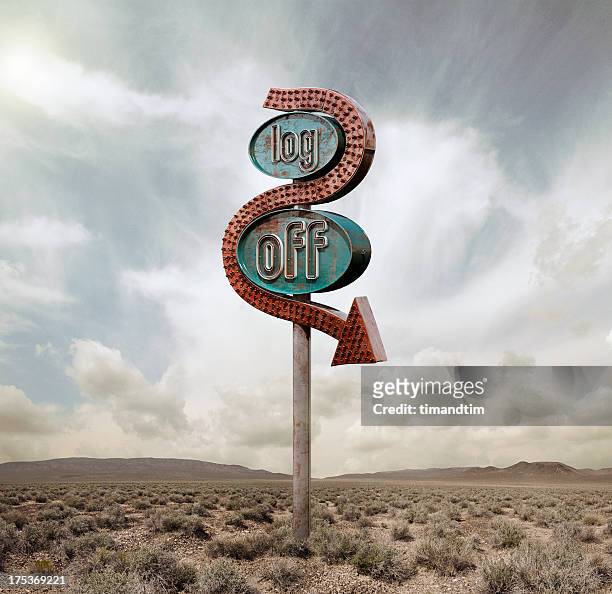 log off neon in the desert - neon sign arrow stockfoto's en -beelden
