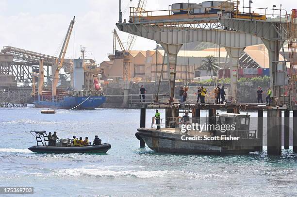 Suspected asylum seekers arrive at to Flying Fish Cove, Christmas Island, after being intercepted and escorted in by the Australian Navy, on August...