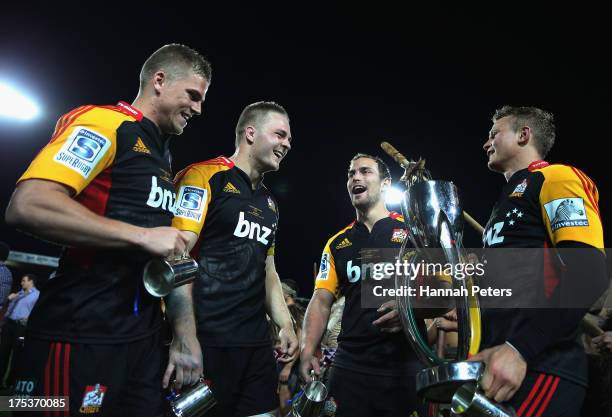 Gareth Anscombe, Sam Cane, Andrew Horrell and Robbie Robinson of the Chiefs celebrate after winning the Super Rugby Final match between the Chiefs...