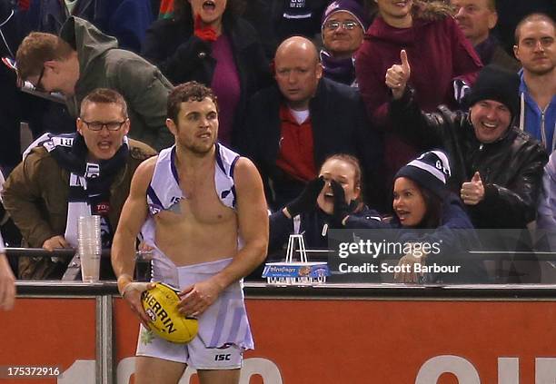 Hayden Ballantyne of the Dockers looks to kick the ball with a ripped jumper during the round 19 AFL match between the Carlton Blues and the...