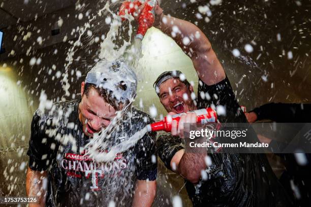 Corey Seager of the Texas Rangers celebrates with his teammates in the locker room after defeating the Houston Astros in Game Seven to win the...