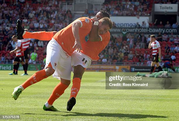 Steven Davies of Blackpool celebrates with Tom Ince of Blackpool after opening the scoring during the Sky Bet Championship match between Doncaster...