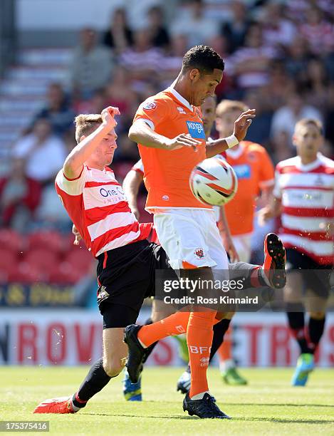 Tom Ince of Blackpool is challenged by James Husband of Doncaster during the Sky Bet Championship match between Doncaster Rovers and Blackpool at...